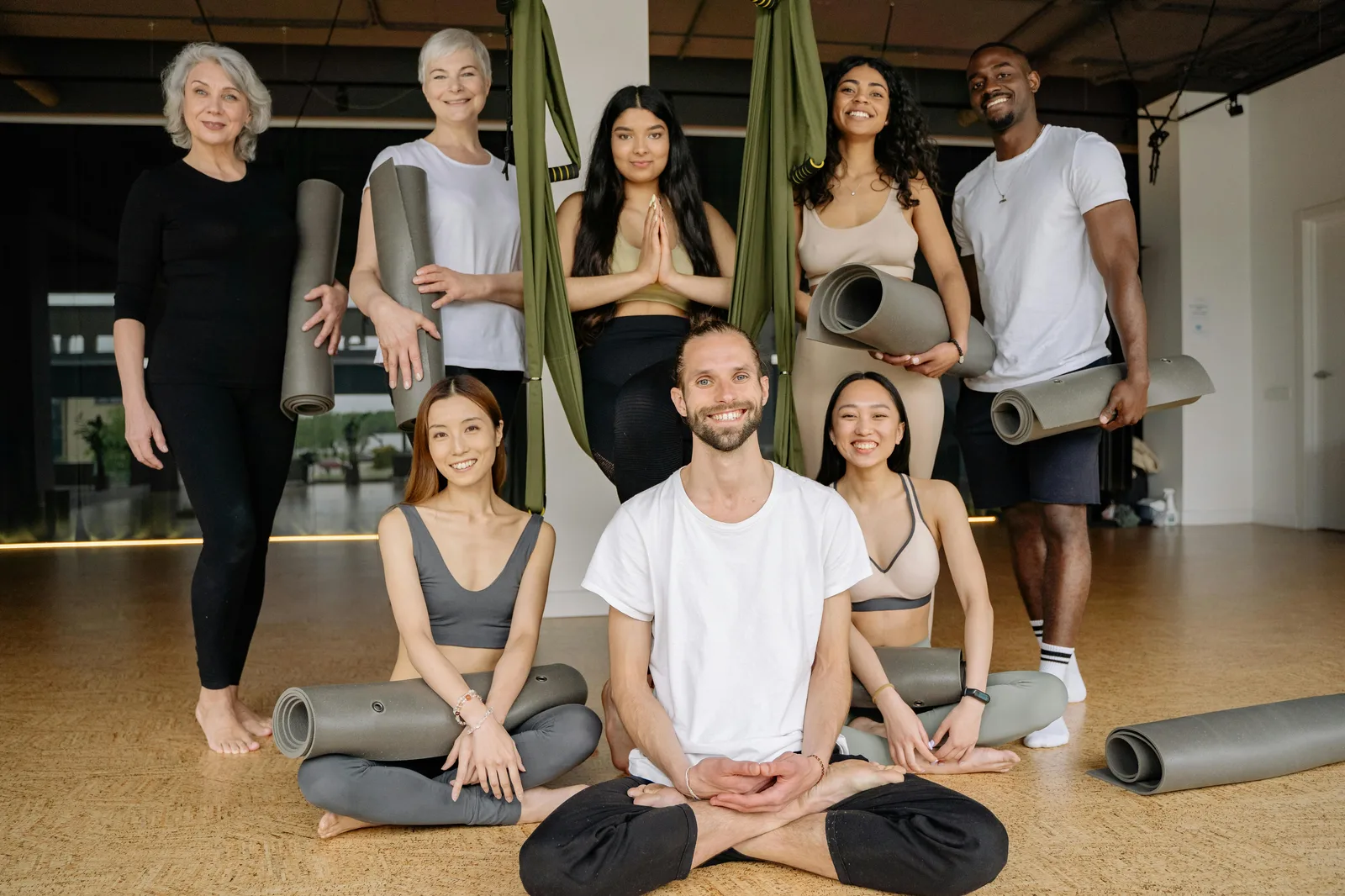 Diverse group smiling together in a yoga studio in Atlanta